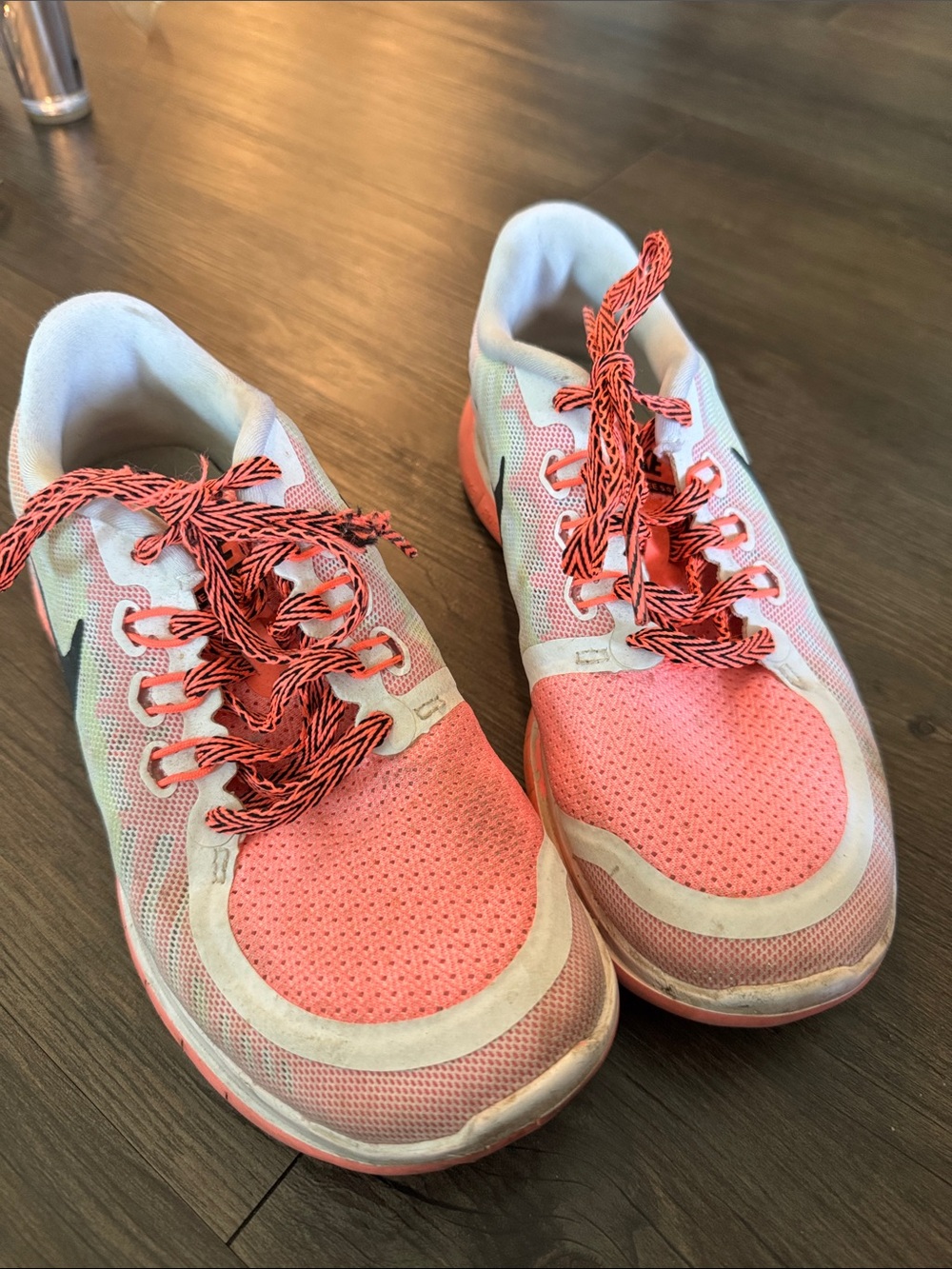 Coral and green Nike sneakers